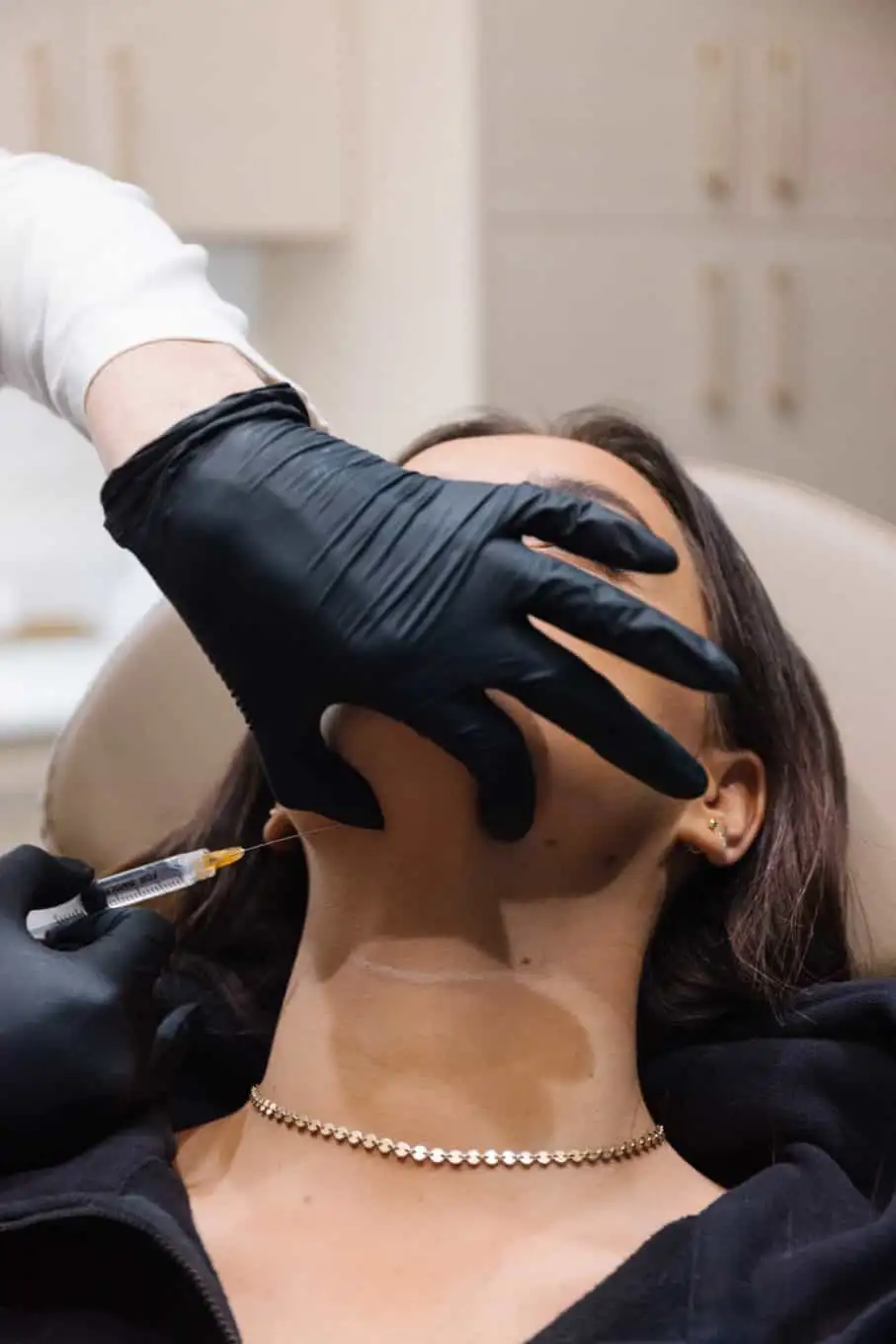 A woman getting kybella injection